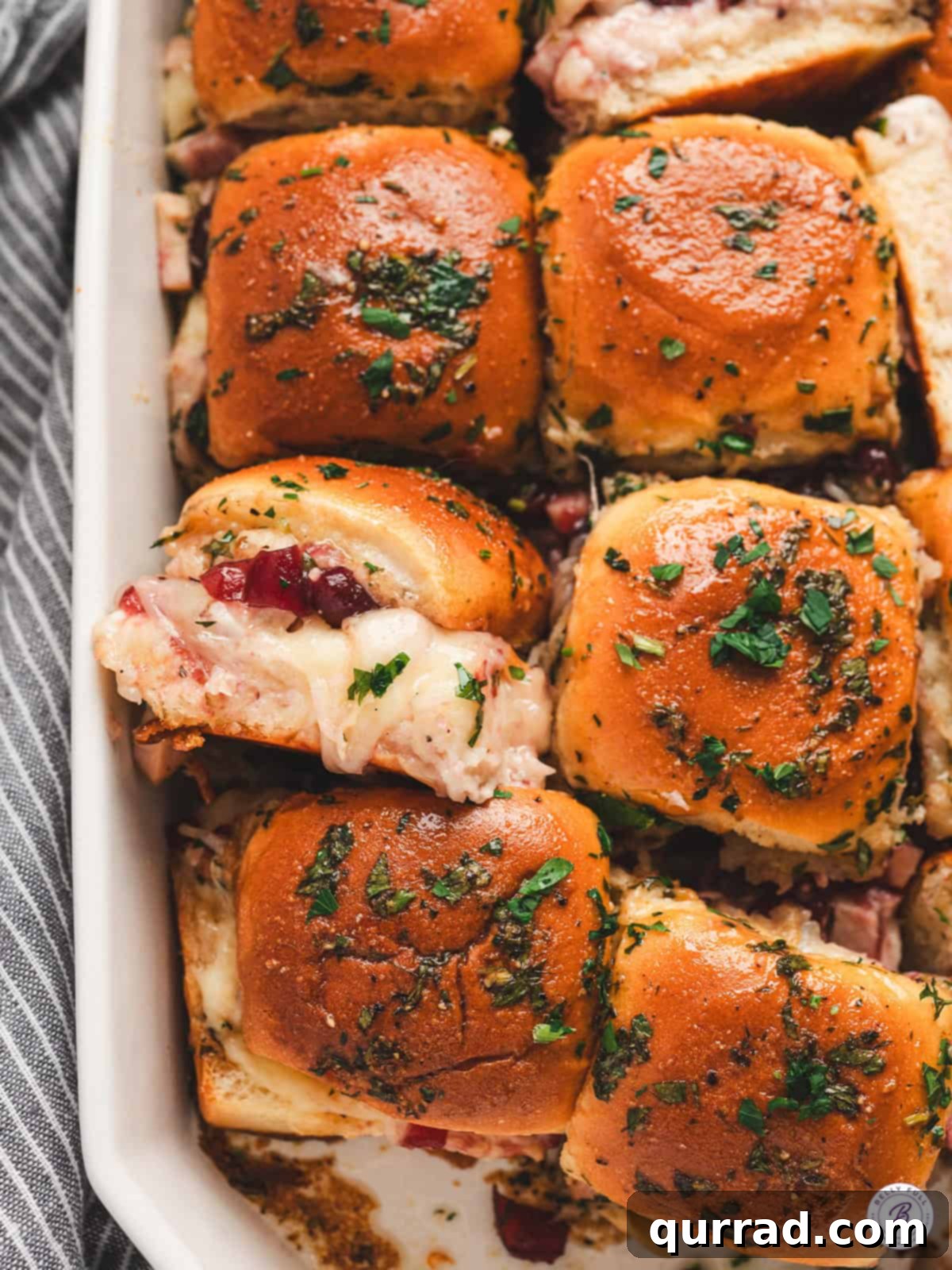 Cranberry Turkey Bites 2 Cranberry Turkey Sliders: Golden baked to perfection, drizzled with a parsley butter glaze.