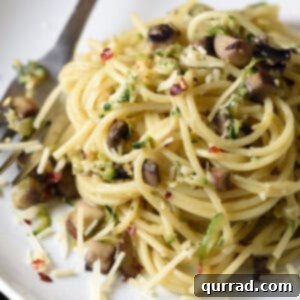 pile of pasta with chopped zucchini and mushrooms