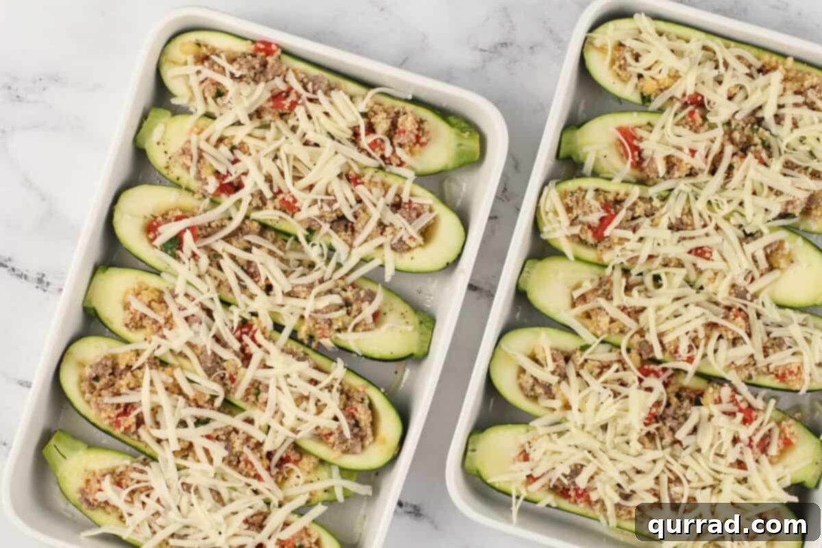 Hearty Italian Zucchini Boats 11 Zucchini halves generously stuffed with filling and topped with mozzarella cheese, arranged in white baking dishes, ready for the oven.