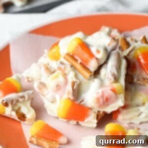 Halloween Candy Corn Pretzel Bark - the ultimate treat with white chocolate, candy corn, and pretzels!
