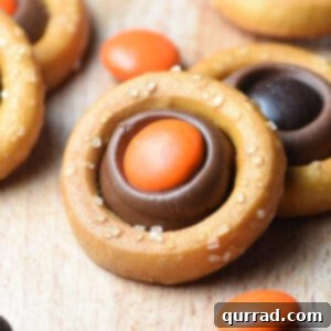 pretzel ring filled with a melted Hershey's kiss and orange M&M