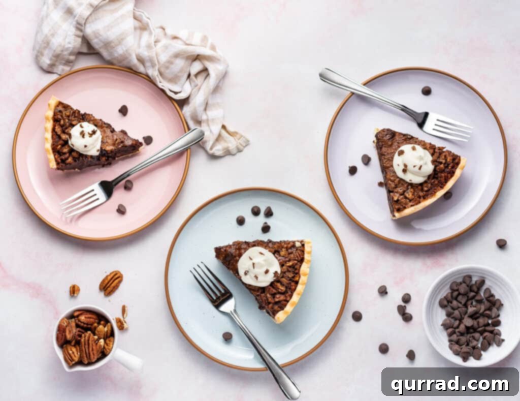 Three plates with forks, each holding a slice of Chocolate Pecan Pie topped with whipped cream, ready for guests.