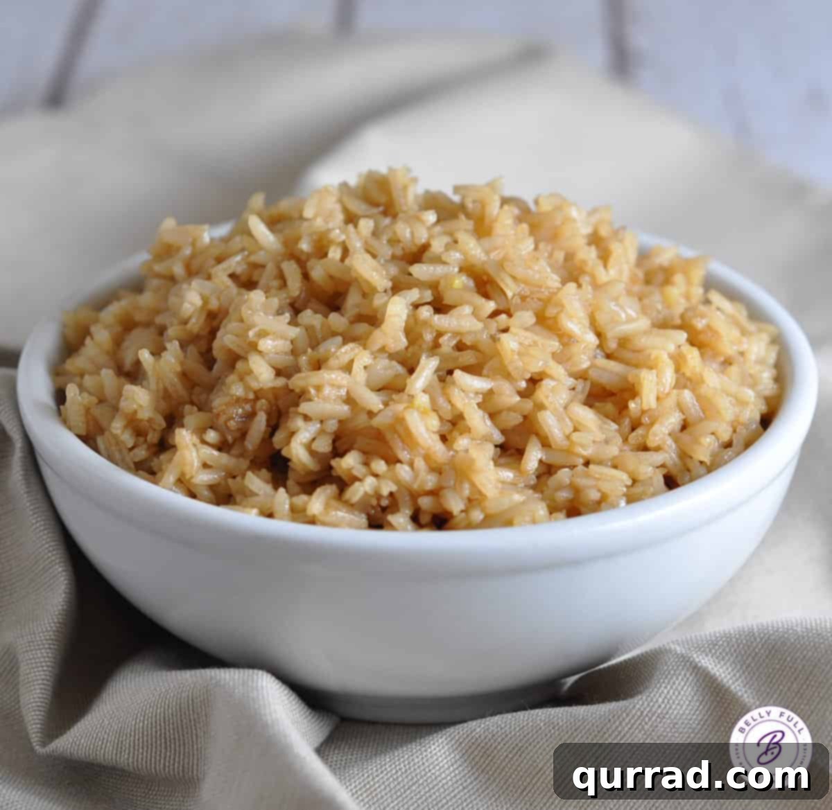 Flawless Rice Pilaf 4 A generously piled bowl of fluffy and creamy rice pilaf, garnished with fresh parsley, ready to be served.