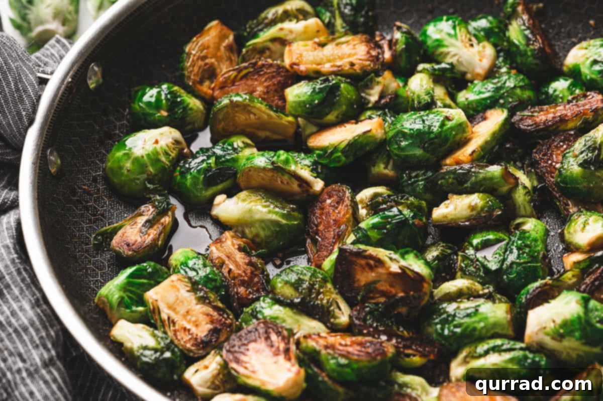 Caramelized Molasses Brussels Sprouts 9 Close-up of sautéed Brussels sprouts in a skillet, caramelized on the cut sides and coated with a glossy molasses glaze.