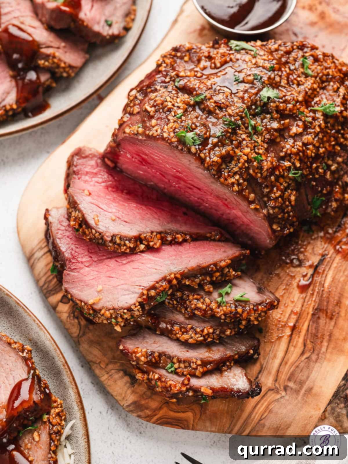 Glazed roasted Tri-Tip sliced on cutting board, showcasing its juicy interior and crispy exterior