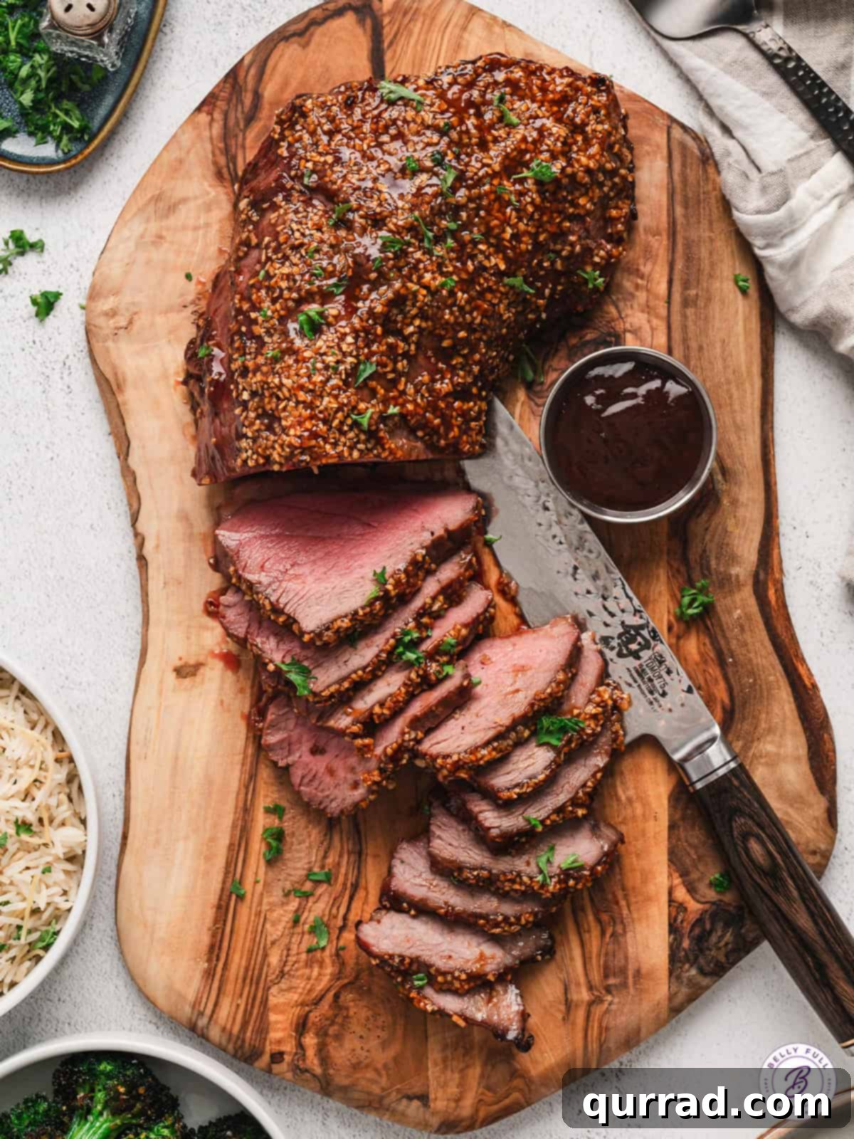 Overhead shot of perfectly glazed roasted Tri-Tip sliced on a cutting board, ready for a feast