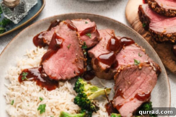 Sliced roasted Tri-Tip on plate with sauce, garnished and ready for serving