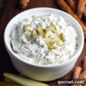 dill pickle dip in small dish with diced pickles on top
