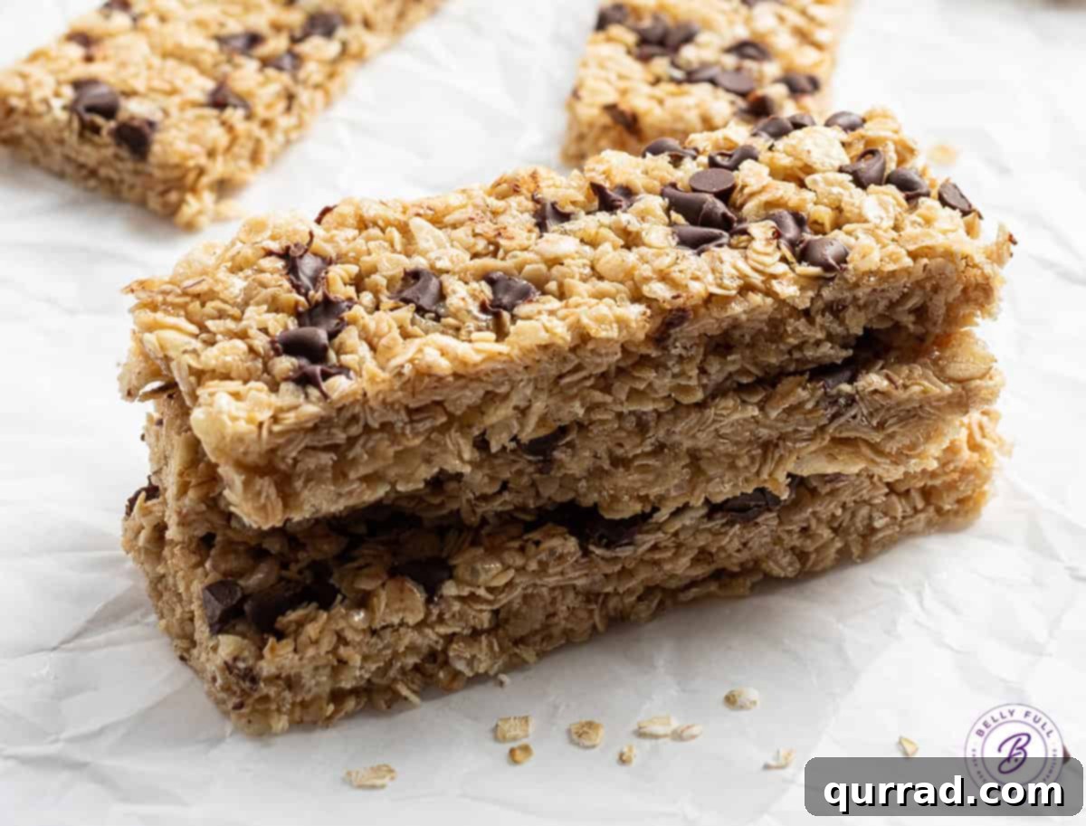 Wholesome Homemade Snack Bars 9 A tidy stack of three homemade granola bars, clearly showing their texture and the distribution of chocolate chips.