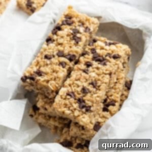 Stacked homemade granola bars in a container, ready to be enjoyed.