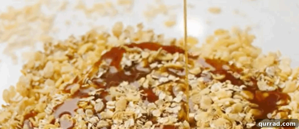 Wholesome Homemade Snack Bars 6 The hot sugar-honey-butter mixture being poured directly over the dry oats and rice cereal in a mixing bowl.