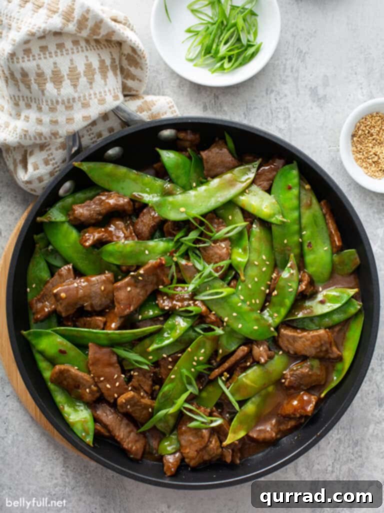 This Stir Fry Beef with Snow Peas is quick, easy, and delicious - on the table in 25 minutes! overhead beef stir fry with snow peas in skillet