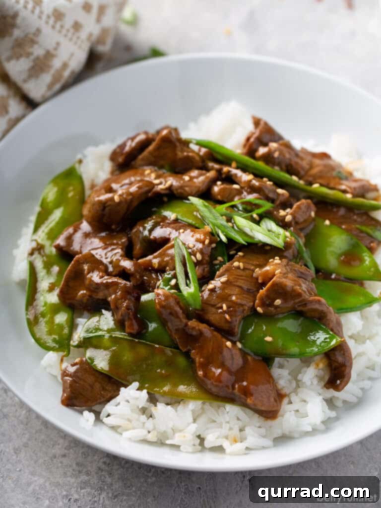 Sizzling Beef Stir Fry 4 stir fry beef with snow peas over white rice in bowl