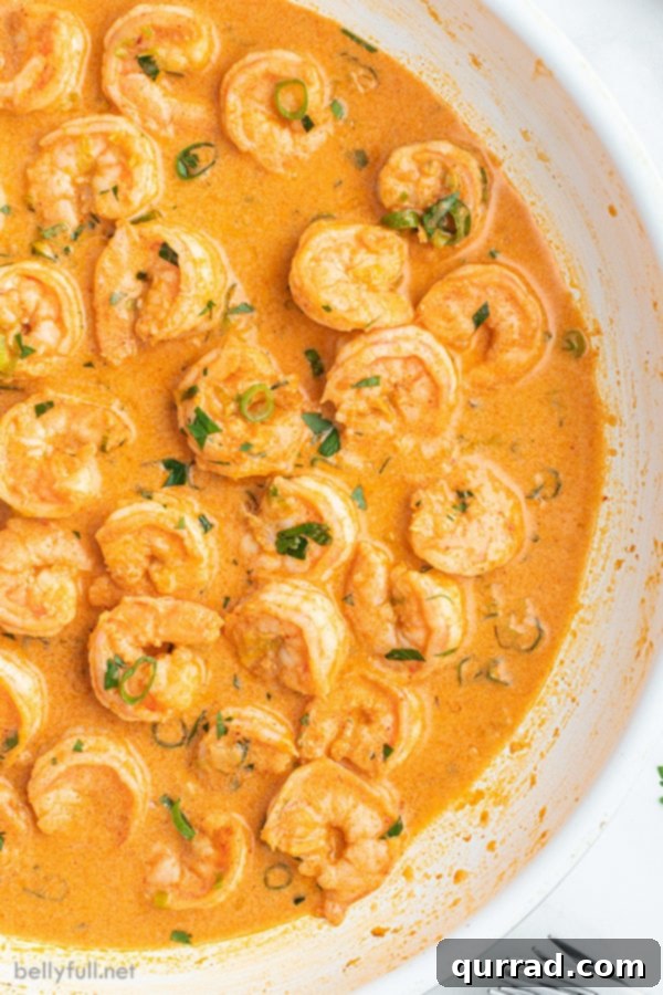 Creamy Thai Coconut Shrimp Curry 2 Close-up overhead view of a vibrant Thai Coconut Shrimp Curry in a serving bowl, garnished with fresh herbs.