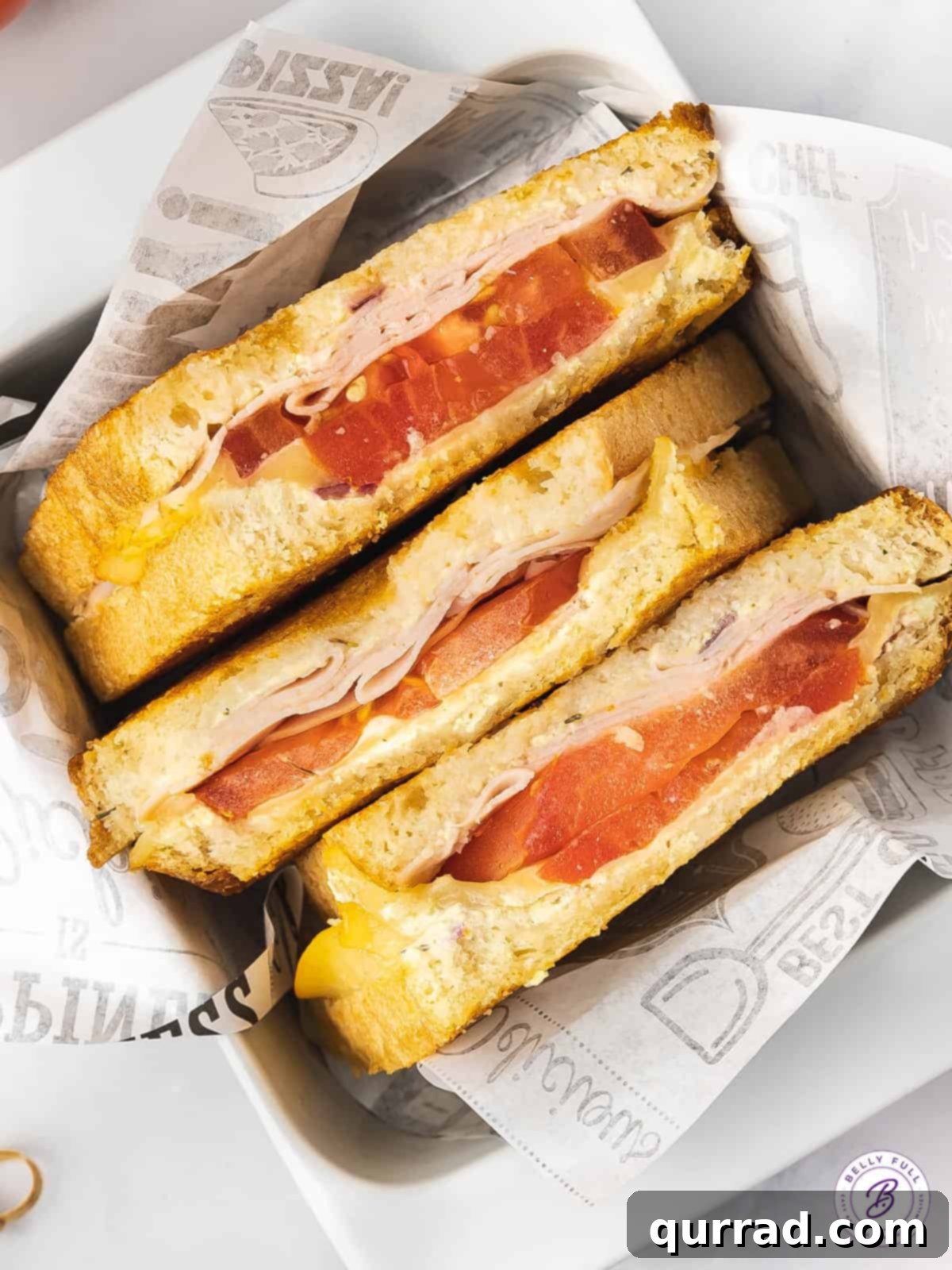 3 half grilled cheese sandwiches with turkey and tomato