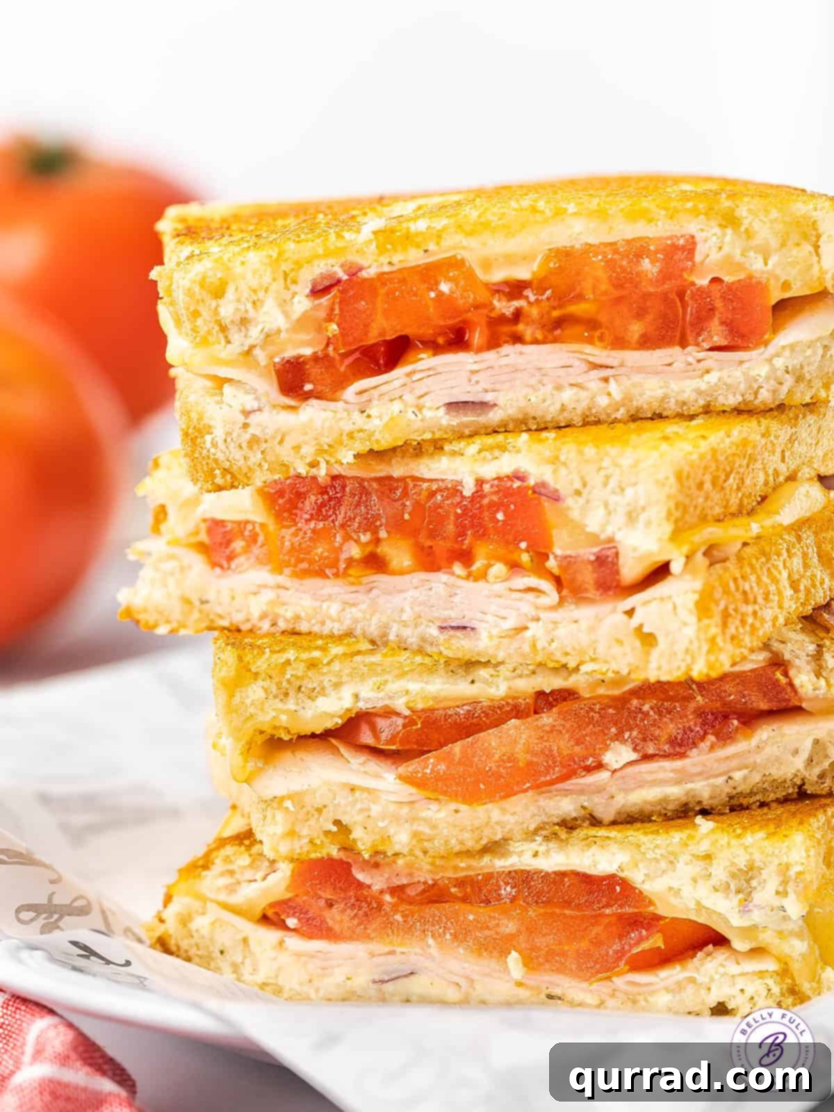 stack of 4 half tomato and turkey grilled cheese sandwiches