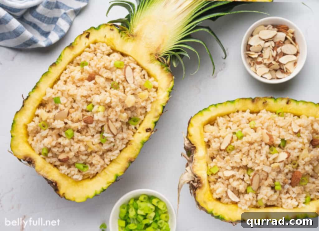 Tropical Coconut Pineapple Rice 4 Two halves of a fresh pineapple, hollowed out and filled with fluffy tropical pineapple coconut rice.