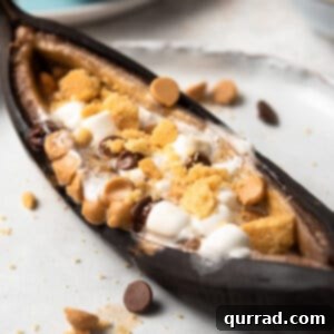 close up roasted banana with s'mores toppings