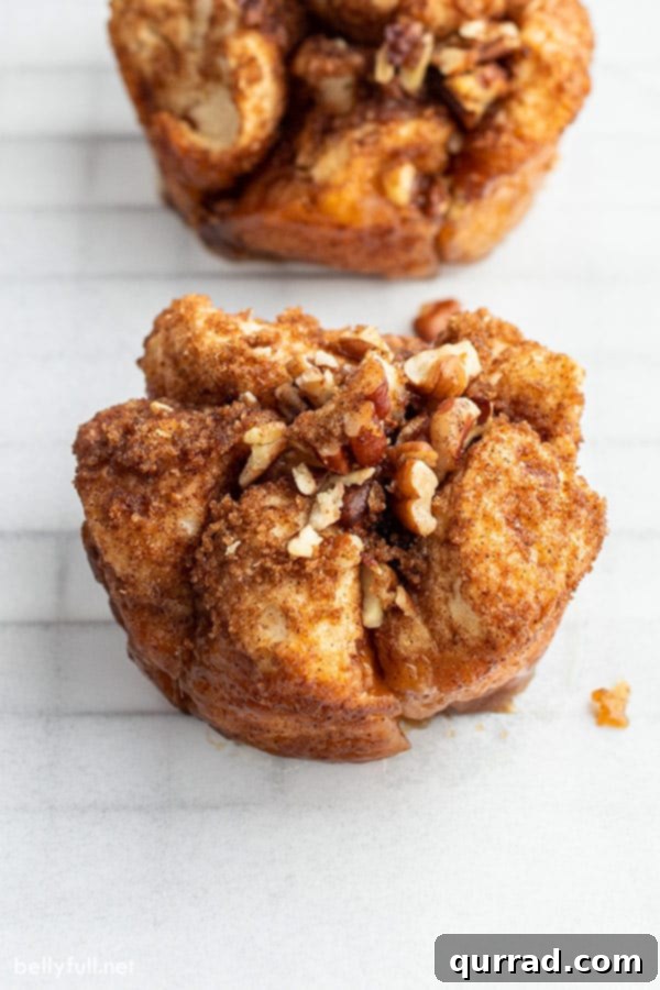 French Toast Muffin Clusters 2 close up of French Toast Muffins on parchment paper, showing their golden-brown exterior and pull-apart texture