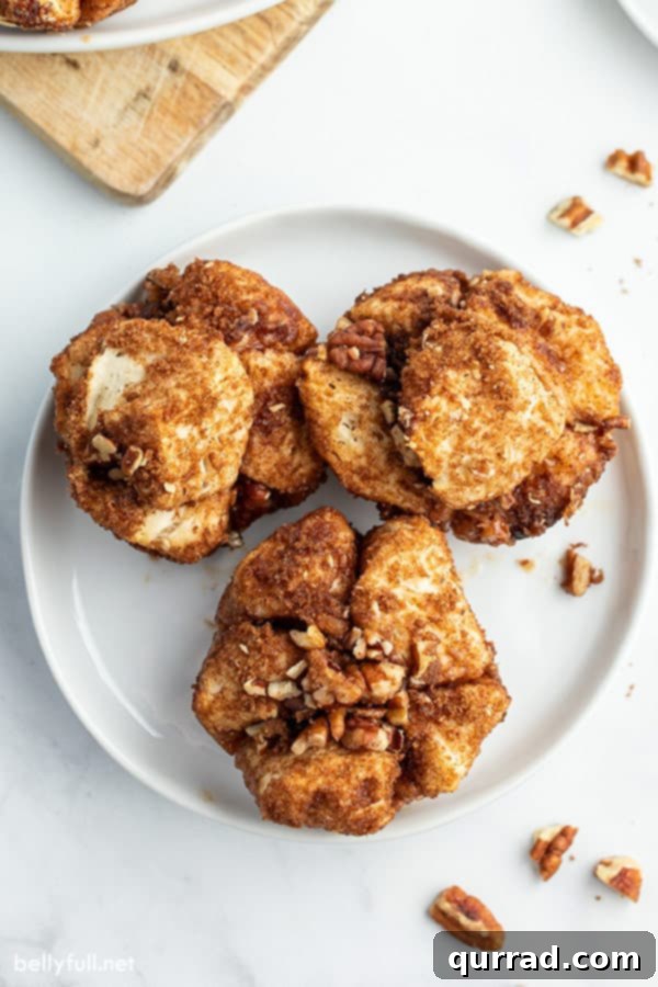 French Toast Muffin Clusters 3 overhead shot of 3 French Toast Muffins arranged on a white plate, highlighting their appetizing appearance