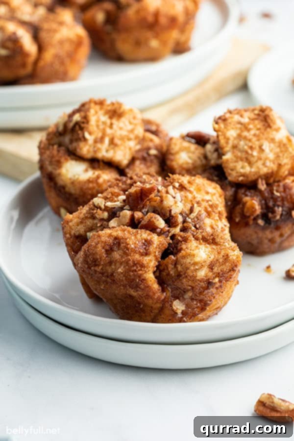 French Toast Muffin Clusters 4 close up of French Toast Muffins on a white plate, showing the soft interior and sticky glaze