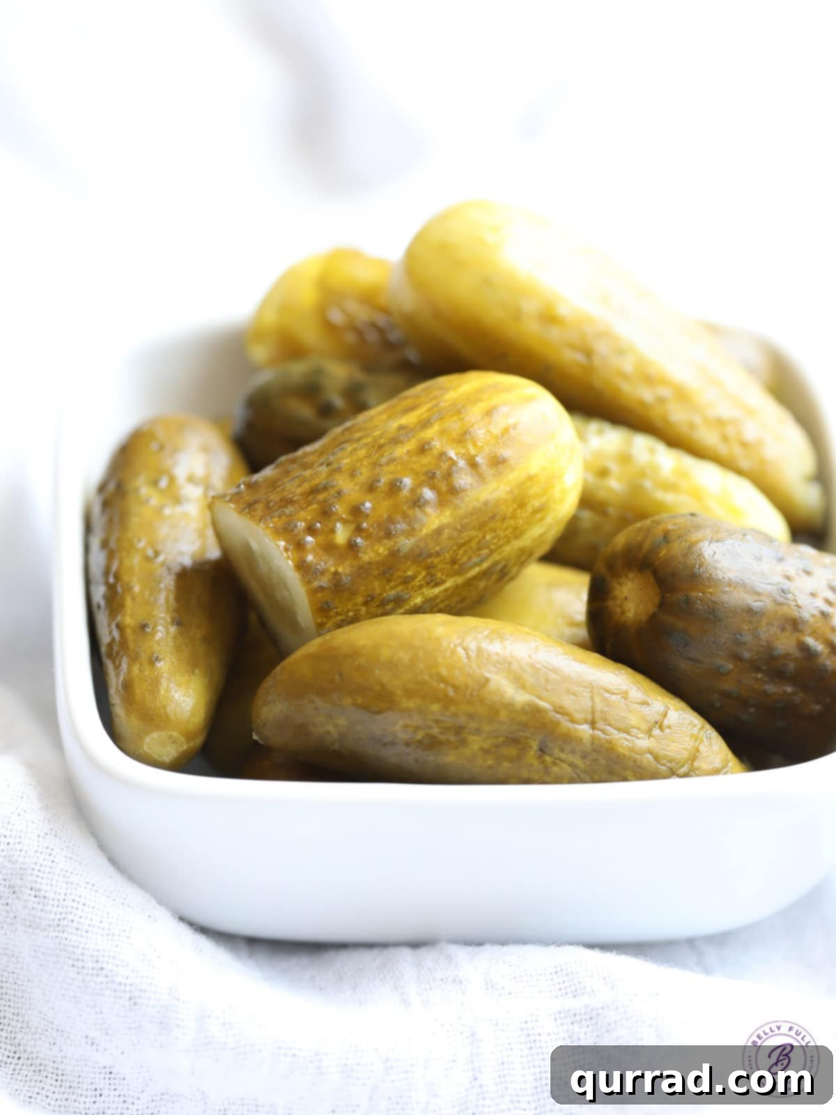 Tangy Dill Pickle Sloppy Joe Melt 3 A bowl filled with whole dill pickles, ready to be diced and added to the sloppy joe mixture.