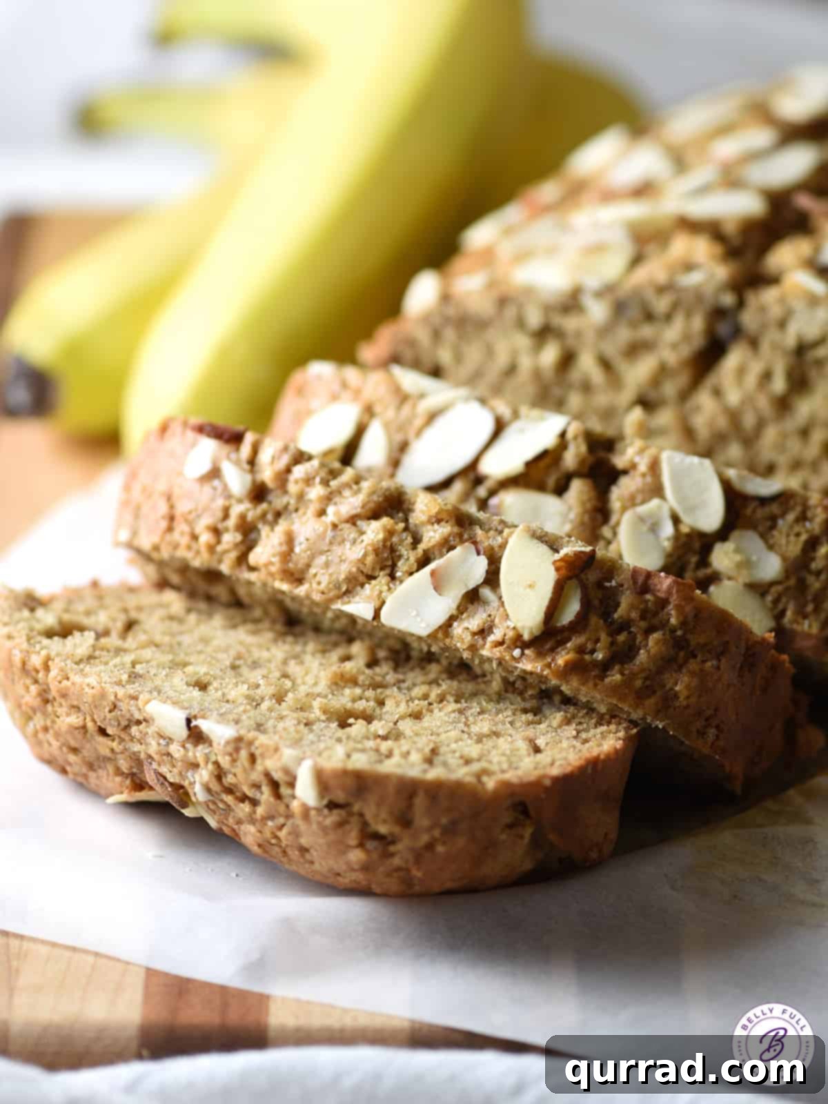Creamy Almond Banana Bread 2 A beautifully sliced loaf of healthy almond butter banana bread, showcasing its moist interior with a golden crust and visible almond slivers on top.