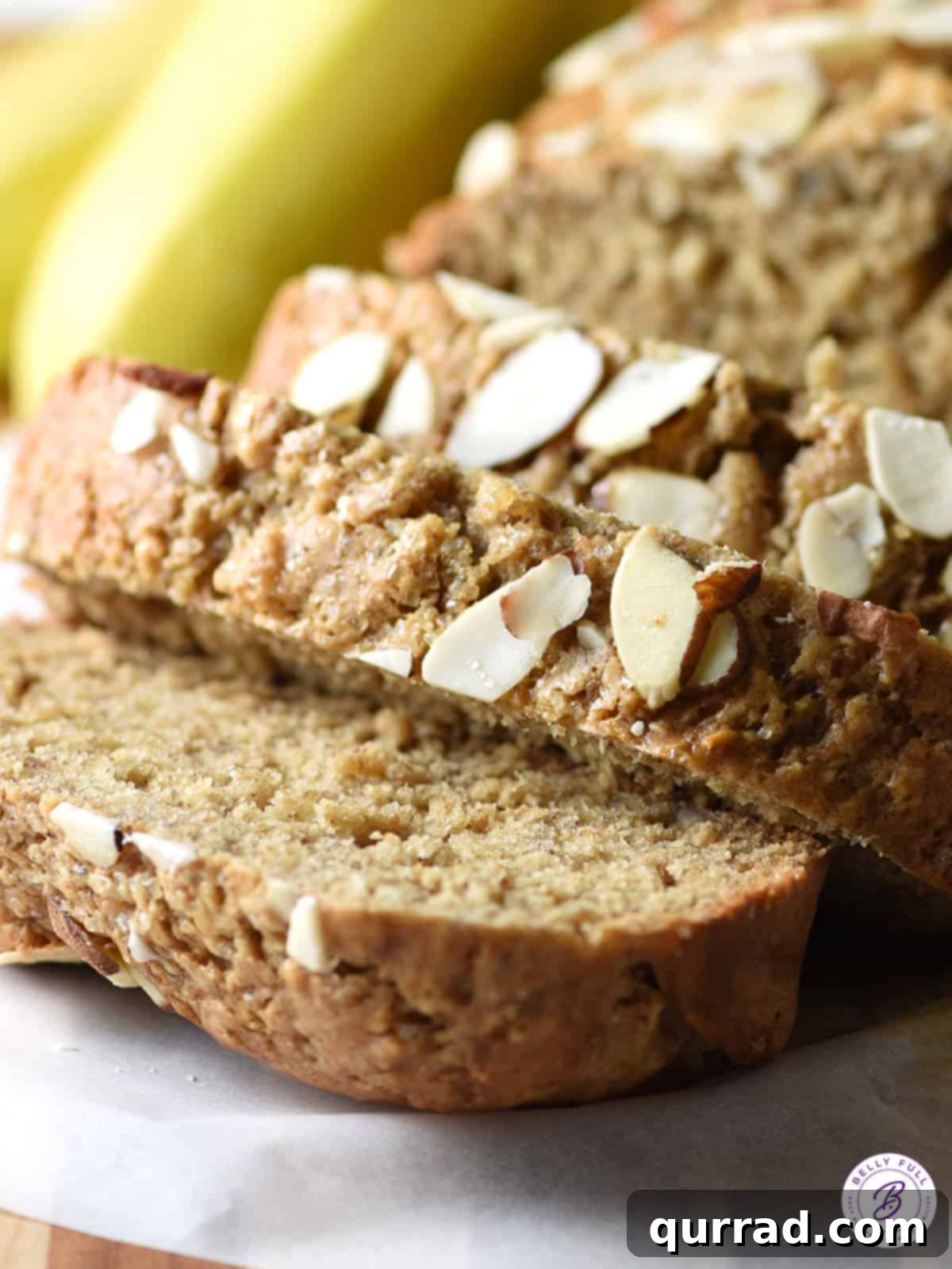 Creamy Almond Banana Bread 4 A close-up view of a single slice of almond butter banana bread, highlighting its rich, moist texture and delicious golden crust.