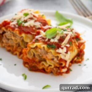 A single serving of baked sausage lasagna rolls on a white plate