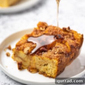 square piece of french toast casserole with syrup being poured on top