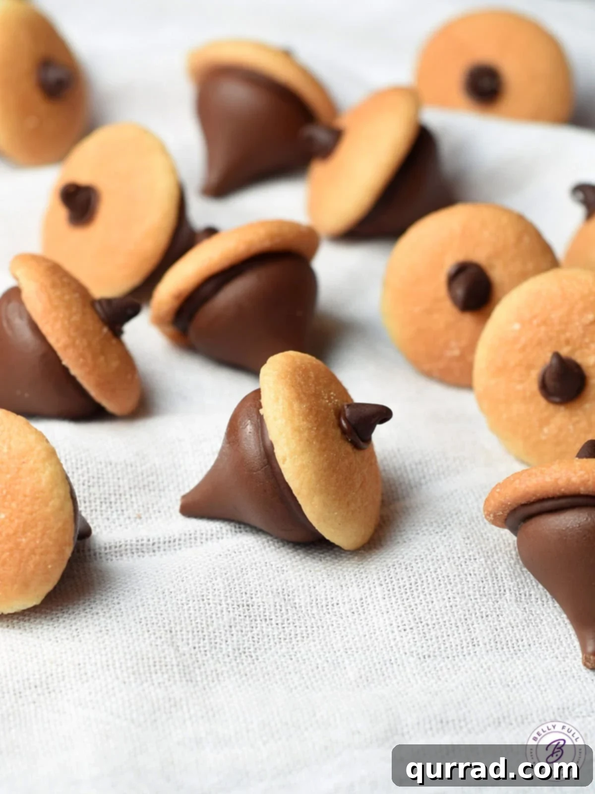 chocolate acorns with mini nilla wafer cookies and Hershey's kiss, arranged on a platter