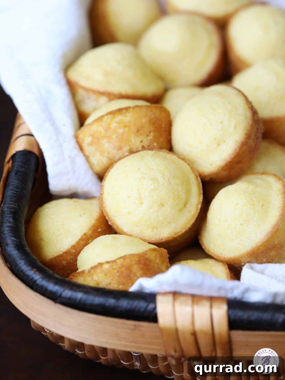 Golden Cornbread Bites 2 A charming basket filled with golden-brown Mini Corn Cake Muffins, perfect for breakfast or a snack.