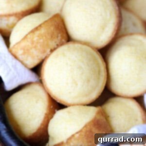 Golden Cornbread Bites 5 Beautifully arranged Mini Corn Cake Muffins in a small basket, showcasing their perfect golden crust and inviting appearance.