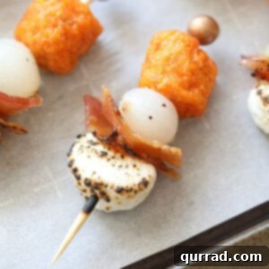 Sweet Potato Casserole Poppers 2 A dish of freshly assembled Sweet Potato Casserole Bites with candied bacon and charred marshmallows.