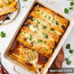 overhead cranberry turkey enchiladas in baking dish with serving spatula