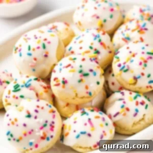 close up pile of Italian Cookies with white icing and rainbow sprinkles