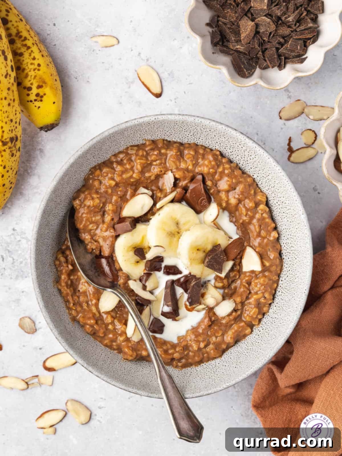 Cocoa-Almond Steel Cut Oatmeal Overhead view of rich chocolate steel cut oatmeal in a bowl, garnished with fresh banana slices.