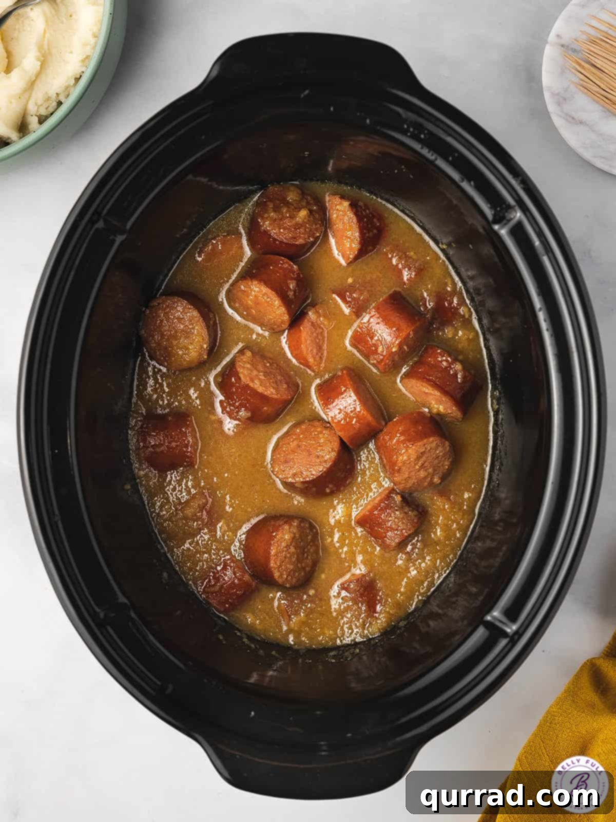 Slow Cooker Apple Kielbasa Poppers 3 apple kielbasa bites in crockpot