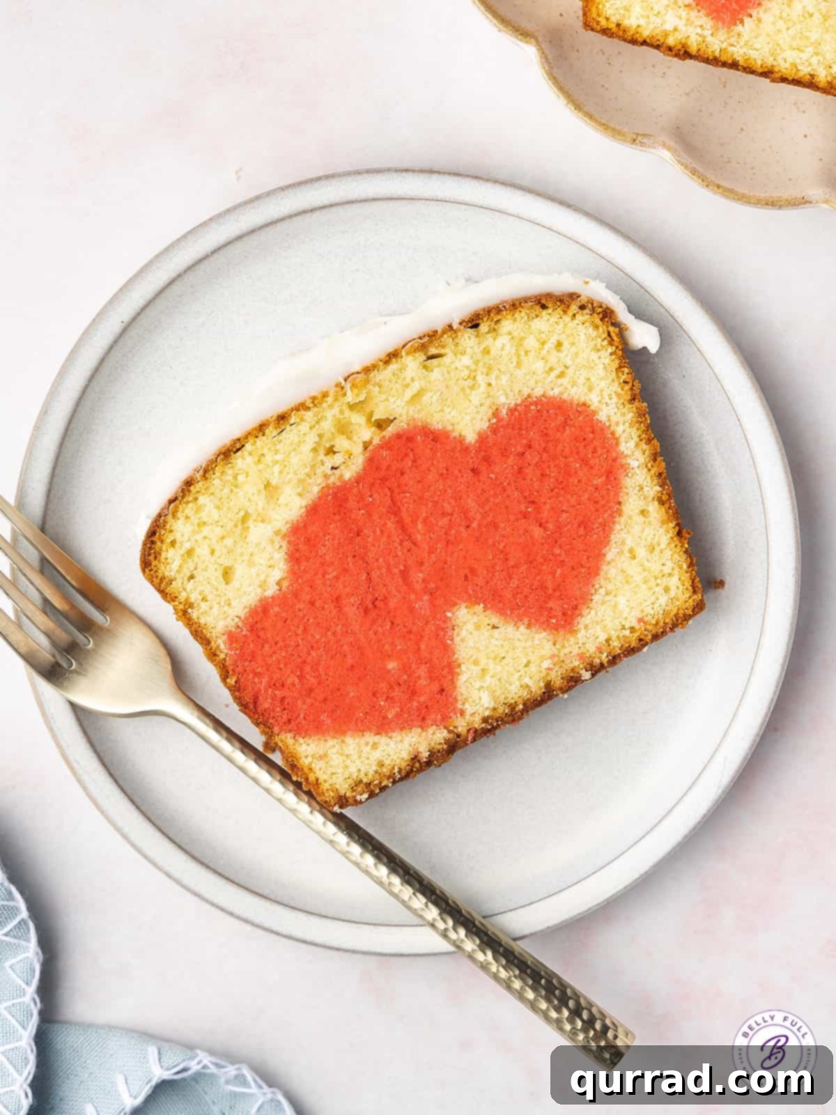 Secret Heart Reveal Cake 2 overhead slice of pound cake with pink hearts and fork