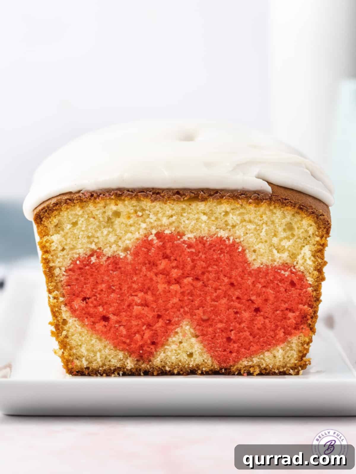 Secret Heart Reveal Cake 3 sliced surprise pound cake loaf with double hearts inside