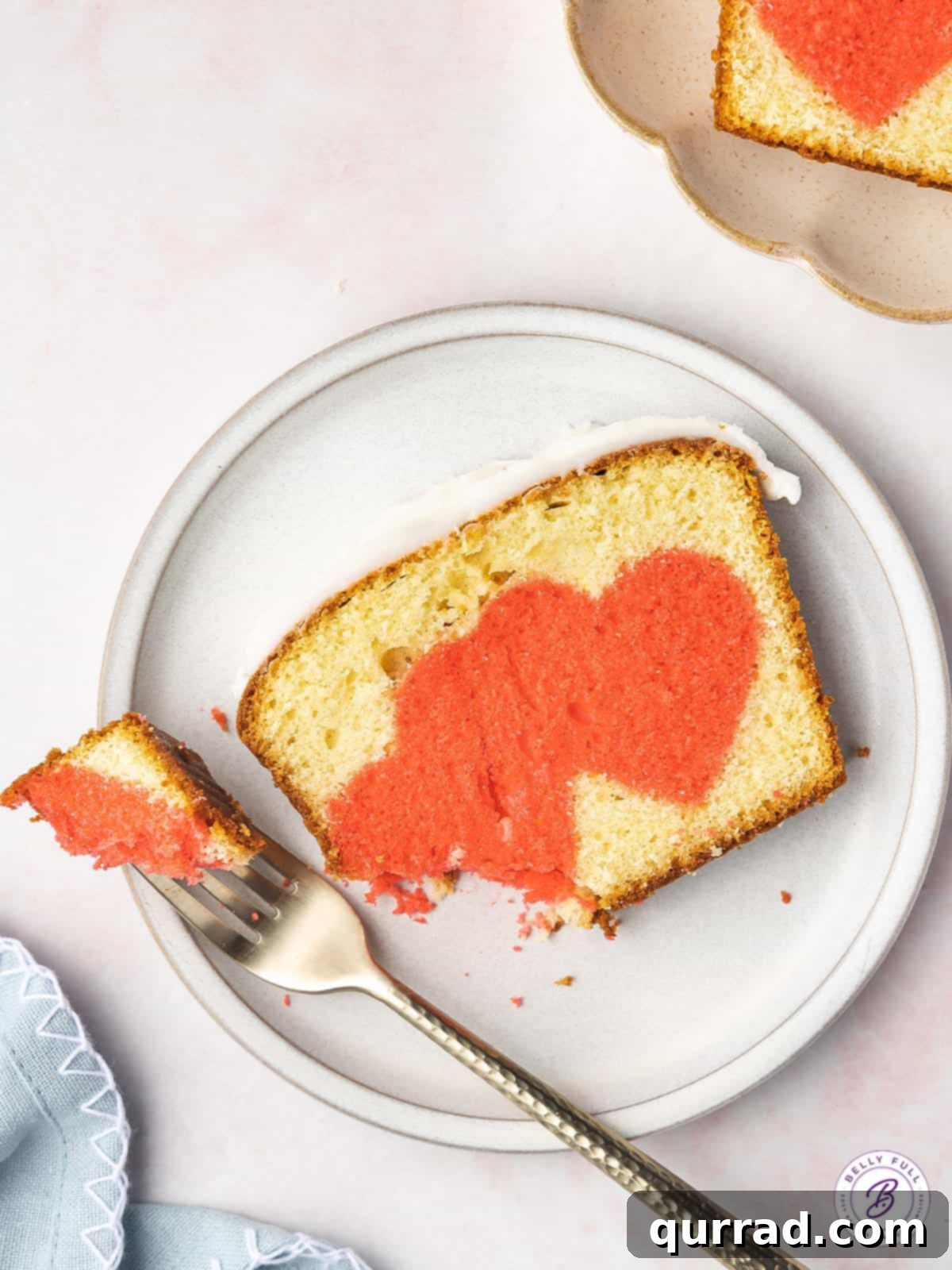 Secret Heart Reveal Cake 7 bite taken of sliced pound cake with pink hearts