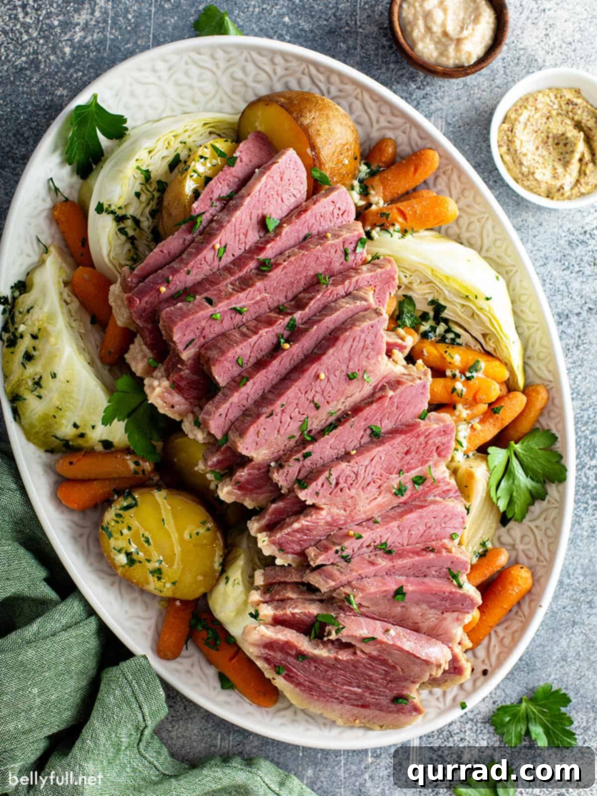 overhead sliced slow cooker corned beef and vegetables on serving platter