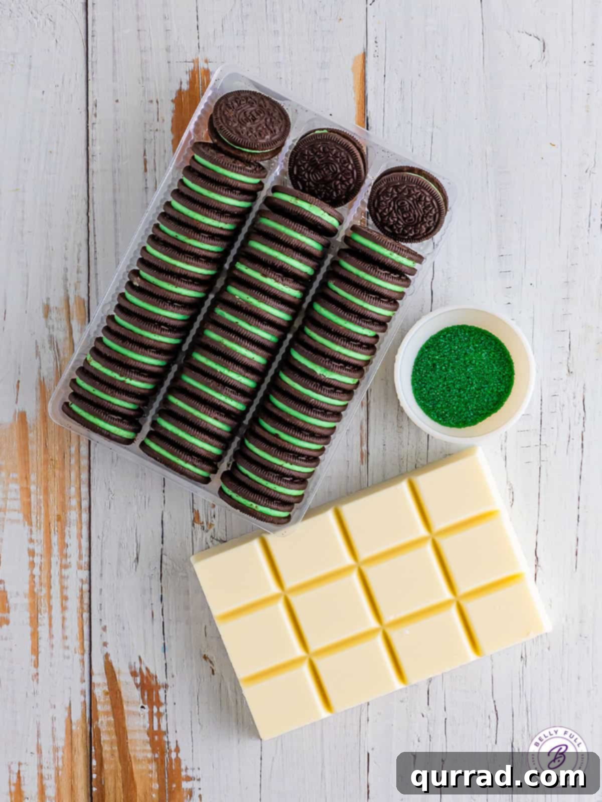 Array of ingredients for making St. Patrick's Day Oreos: mint Oreos, almond bark, and green sanding sugar.
