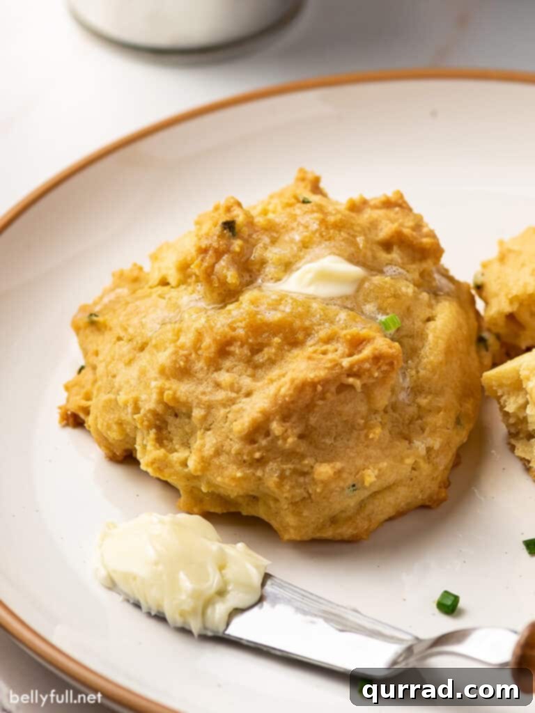 baked drop biscuit with melted butter on plate