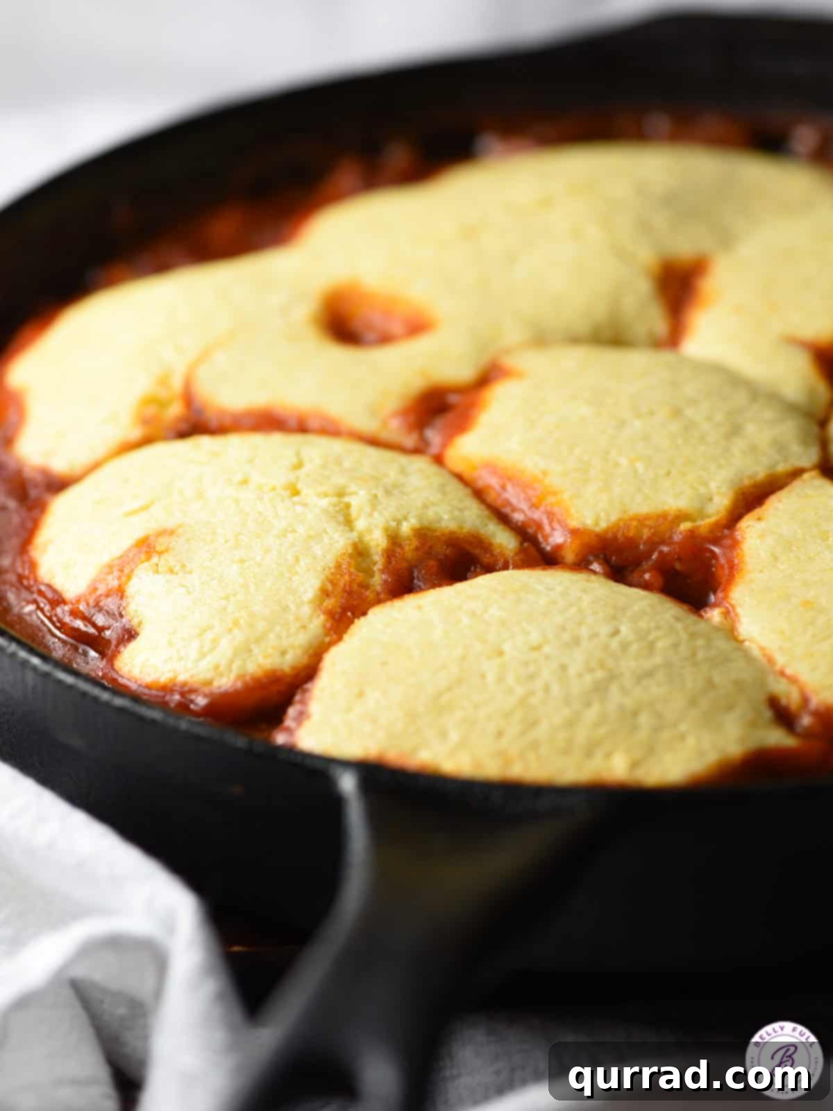 Golden Cornbread Sloppy Joe Pie 3 Golden, fluffy cornbread topping baked directly onto a savory sloppy joe filling in a rustic cast iron skillet.