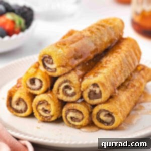 stack of French Toast Rolls on plate with maple syrup
