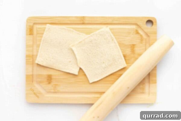 two sliced of sandwich bread flattened with rolling pin