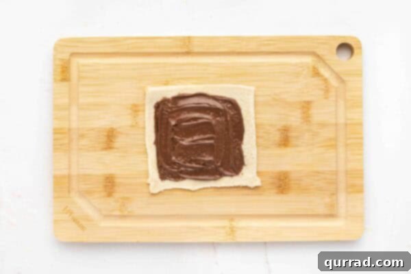 flattened sandwich bread with nutella spread