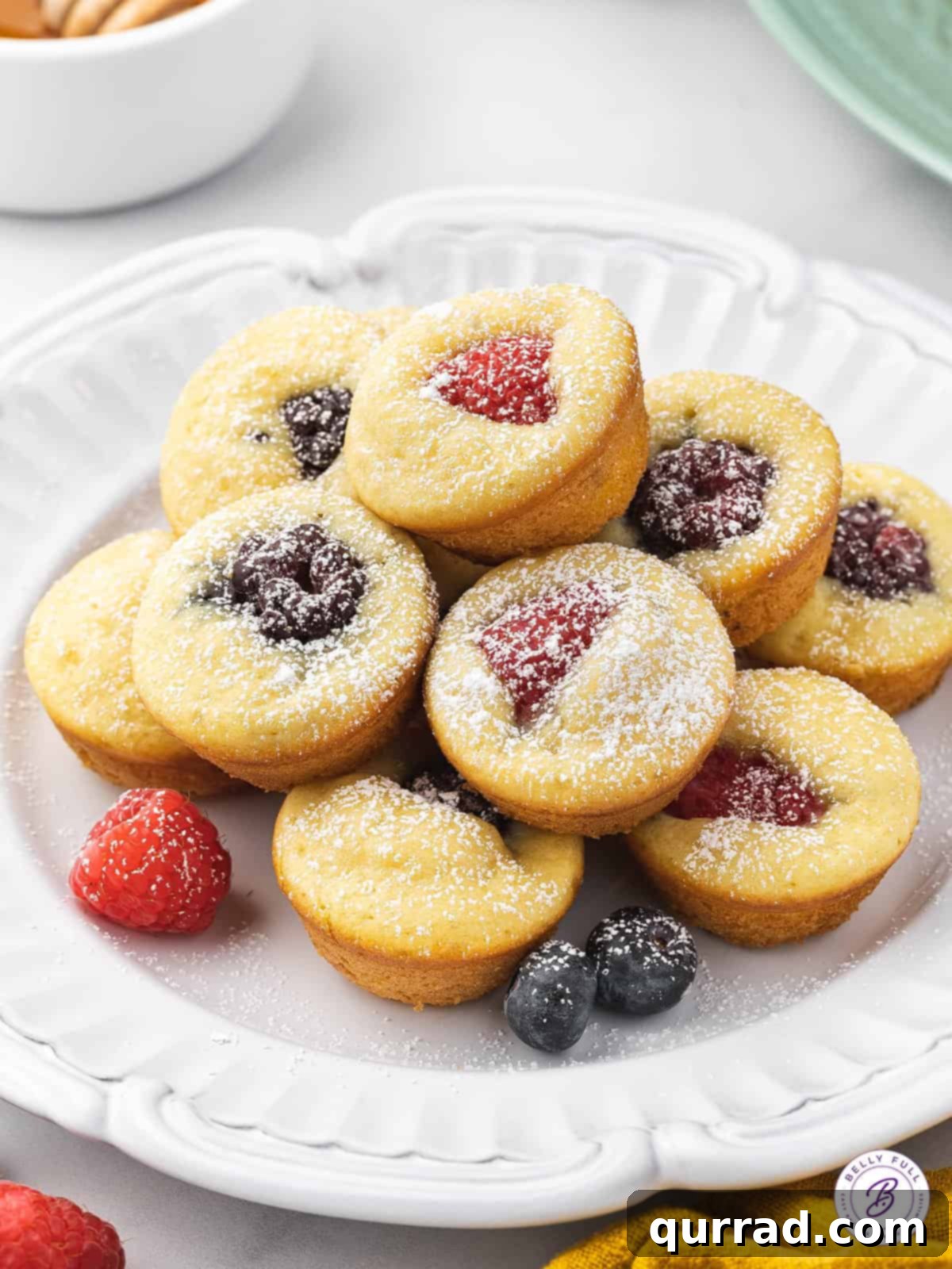 Pancake Poppers 6 Plate full of mini pancake muffins dusted with powdered sugar