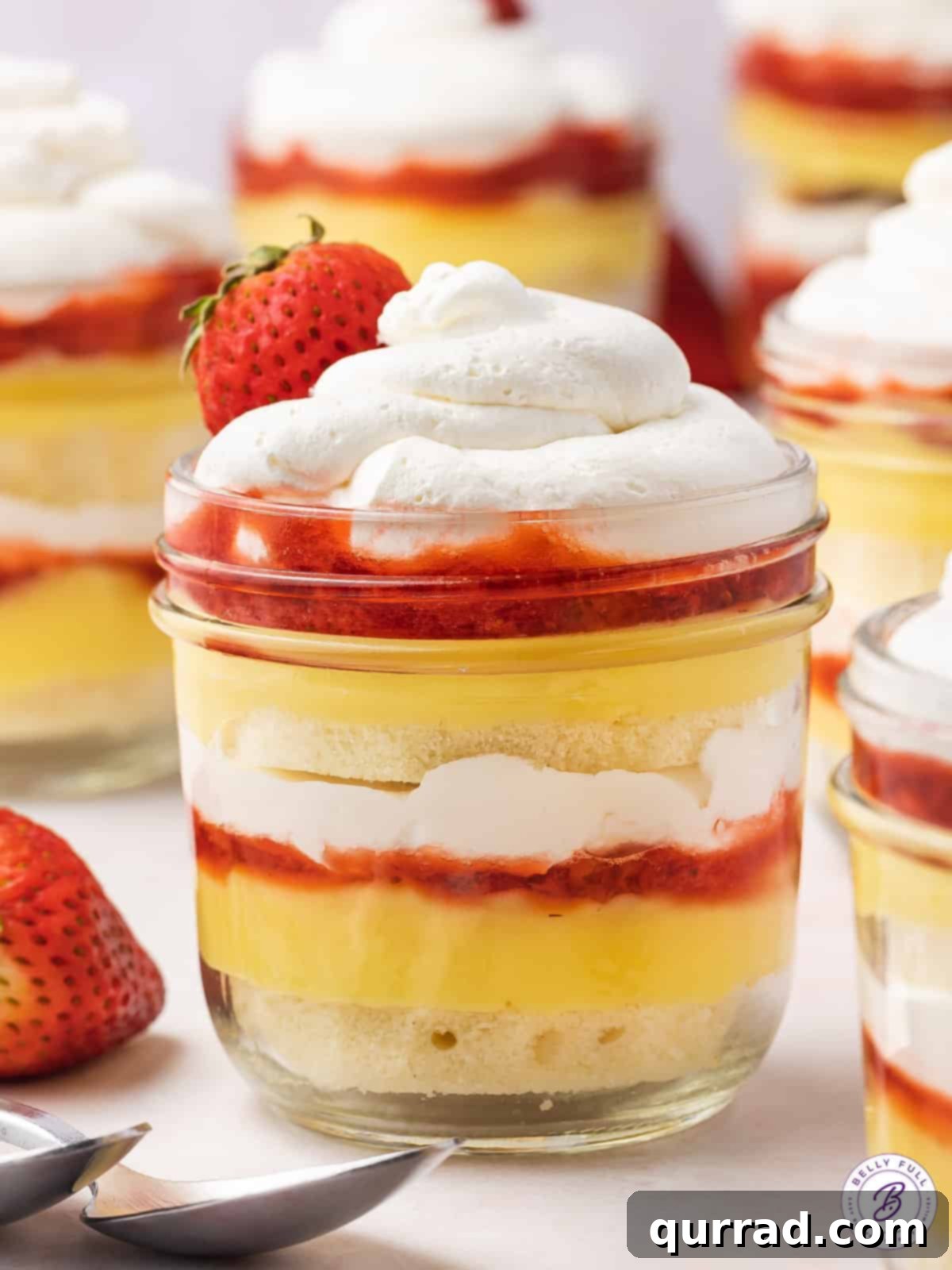 Strawberry Shortcake Layers of Sweetness 5 Close-up of a mini strawberry shortcake trifle beautifully layered in a glass jar, ready to be enjoyed
